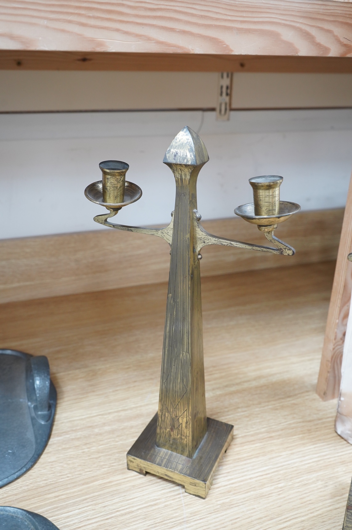 A pair of Jugendstil Arts and Crafts brass two branch candelabra, 37cm high